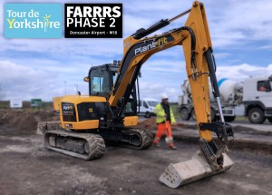 Plant-fit's excavator is shown working at Rossington for the FARRRS project & tour de yorkshire